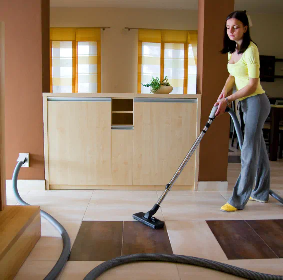 woman cleaning using the central vacuum system